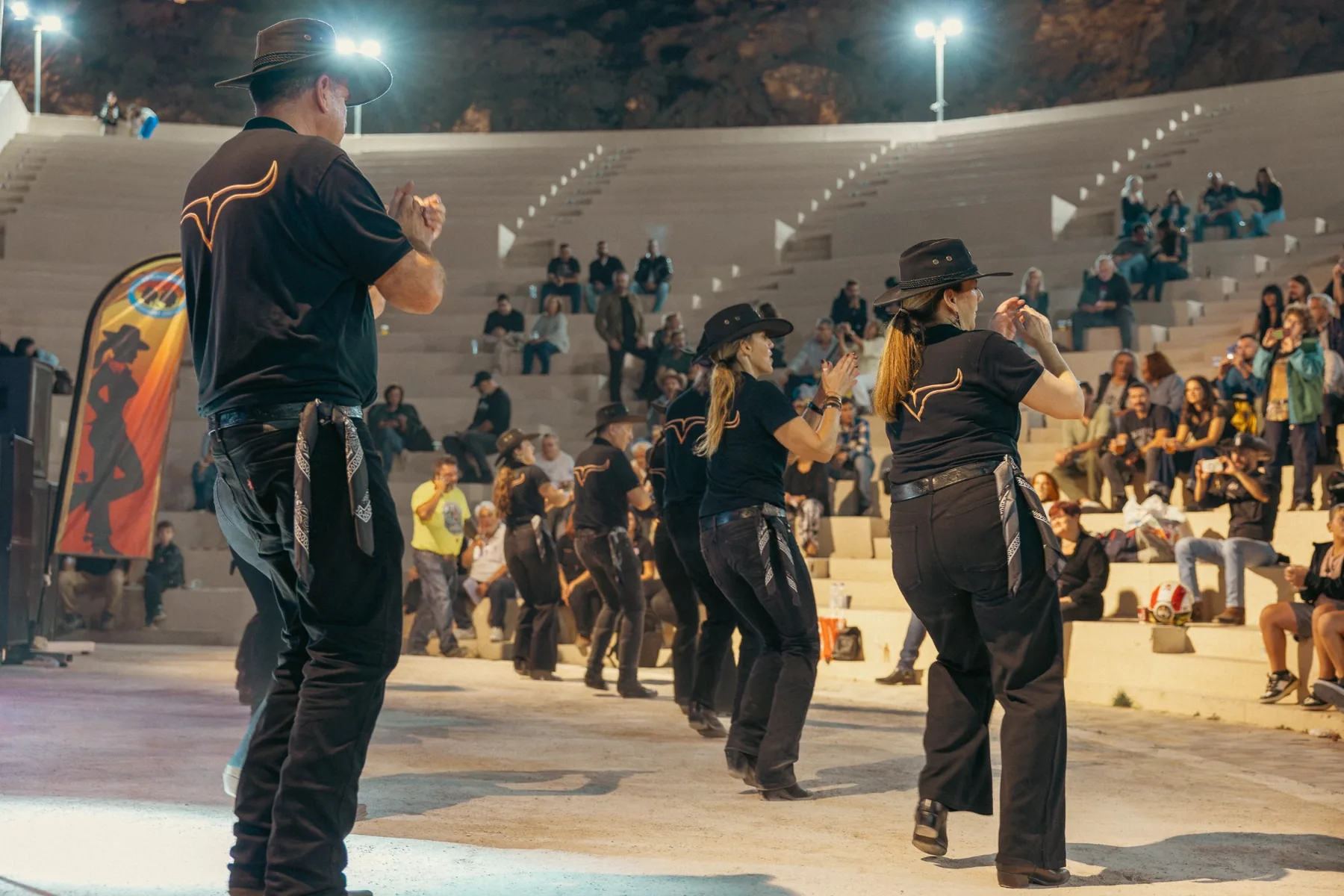 Group performing a line dance at Petra Theatre